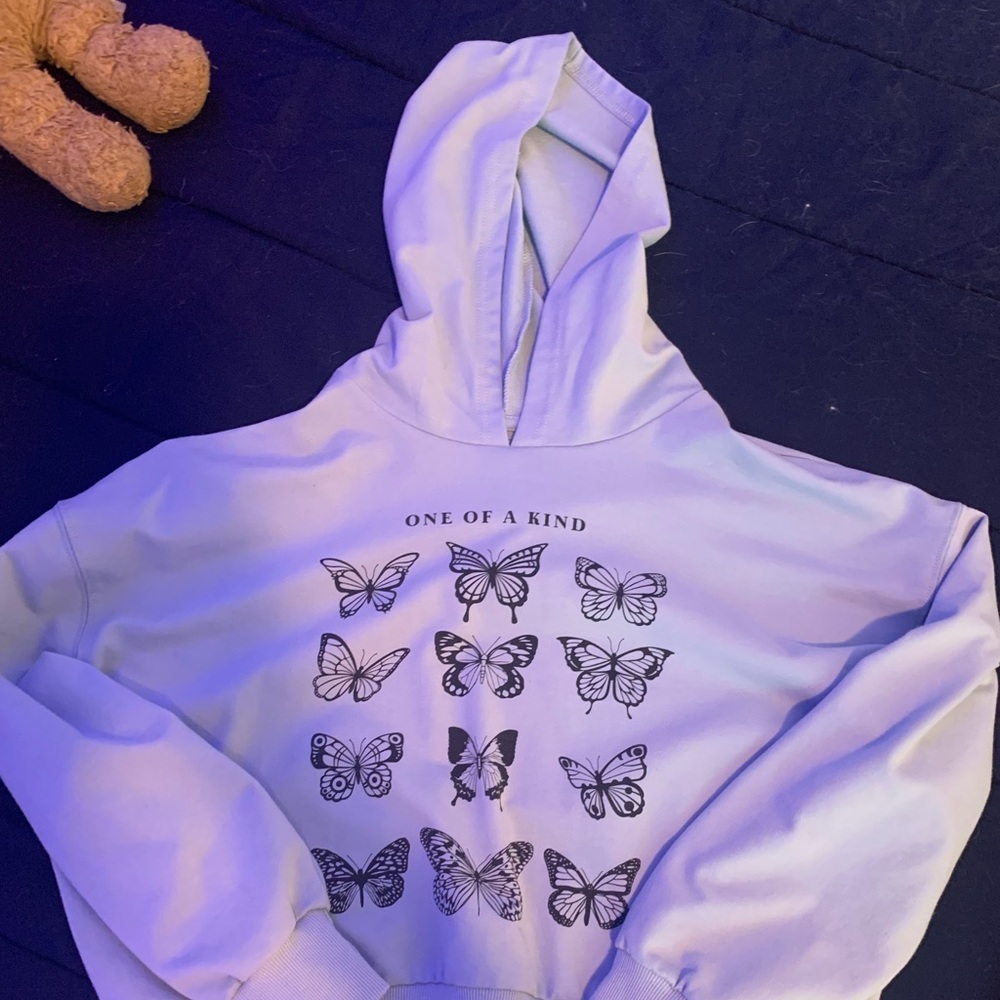 A small hoodie with butterflies on it